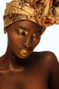 Portrait of beautiful african woman with creative gold makeÃ¢â¬âup and turban